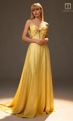 A woman wears the Lucci Lu 1477, a long yellow prom dress with a corset bodice, large bow detail, thin straps, and an elegant A-line silhouette in a softly lit studio.