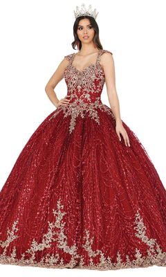 A woman stands with one hand on her hip, wearing the Quinceanera Dress 1478 by Dancing Queen—a red ball gown with a lace embroidered corset bodice, silver embellishments on the cap sleeves, and a matching silver crown.