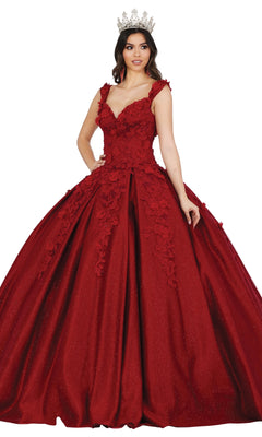 A woman wearing the Quinceanera Dress 1501 by Dancing Queen, an off-the-shoulder a-line ball gown with floral embellishments and a sparkling crown, stands against a white background.