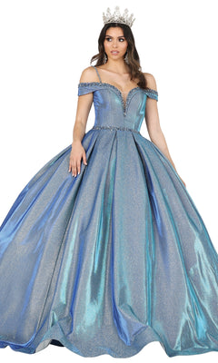 A woman wears the Quinceanera Dress 1506 by Dancing Queen—an off-the-shoulder, silver-blue A-line gown with a sweetheart neckline and a tiara—standing against a white background.