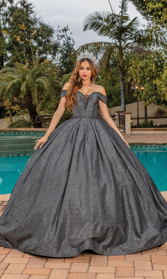 A woman wearing the Quinceanera Dress 1506 by Dancing Queen, an off-the-shoulder a-line gown with a sweetheart neckline, stands by a swimming pool framed by lush tropical trees.