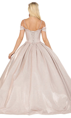 A woman is shown from behind in the Quinceanera Dress 1506 by Dancing Queen—a shimmering blush pink A-line ball gown with off-the-shoulder straps and a lace-up back.