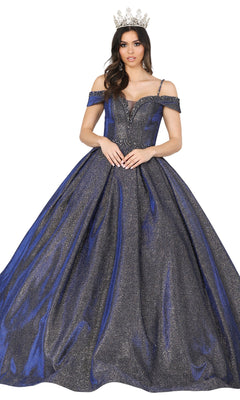 A woman in a crown wears the Quinceanera Dress 1506 by Dancing Queen, an off-the-shoulder blue and silver A-line ball gown with a full skirt, standing against a white background.