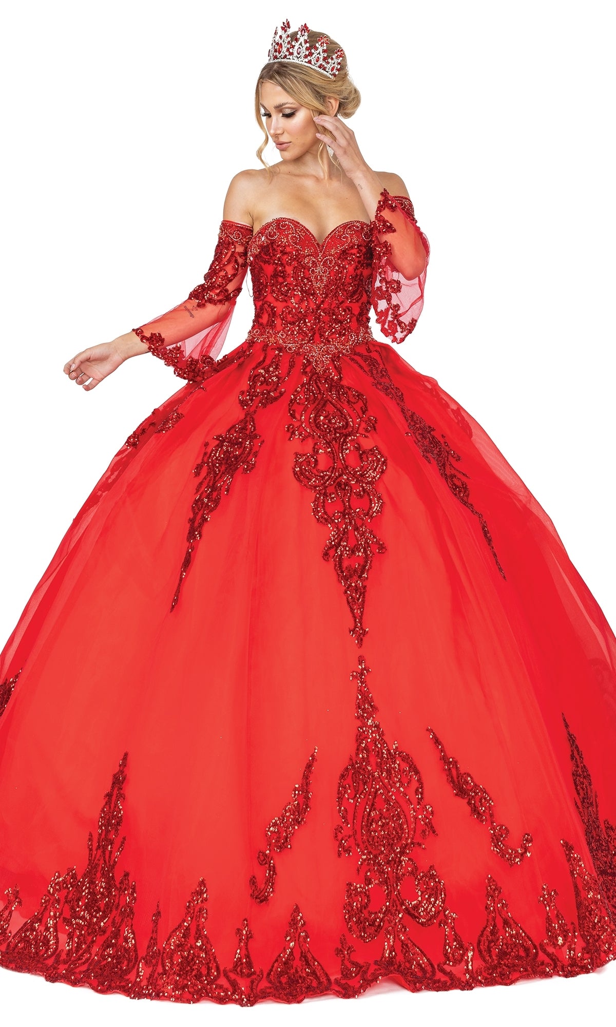 A woman in the vibrant red Quinceanera Dress 1512 by Dancing Queen, featuring a strapless sweetheart bodice, removable sheer sleeves, red accents, and a jeweled tiara, poses against a white background.