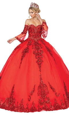 A woman in the vibrant red Quinceanera Dress 1512 by Dancing Queen, featuring a strapless sweetheart bodice, removable sheer sleeves, red accents, and a jeweled tiara, poses against a white background.