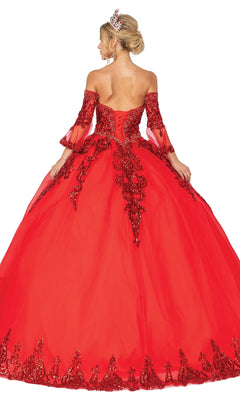 A woman with an updo and tiara wears the Quinceanera Dress 1512 by Dancing Queen, featuring an a-line ball gown silhouette, lace and sequin details, removable sheer sleeves, and her back turned to the camera.
