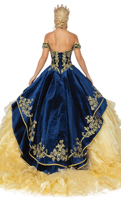 A person in a blue and gold Quinceanera Dress 1529 by Dancing Queen, featuring embroidered details, off-the-shoulder sleeves, a crown, and an elegant A-line silhouette shown from the back.