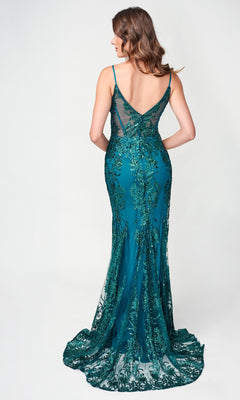 A woman stands facing away in front of a plain light background, wearing the Nina Canacci 1562—a teal, sleeveless, floor-length mermaid dress featuring lace, sequin detailing, and hot stone embellishment.
