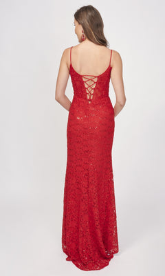 A woman models the Nina Canacci 1568 long formal dress, featuring sleeveless sequin lace, a lace-up back, and a thigh-high slit, standing against a plain white background.
