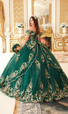 A woman wears the Ladivine 15701 Glitter Quince Dress, a green and gold off-the-shoulder ball gown featuring a back bow.