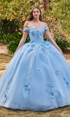 Outdoors, a woman wears the Ladivine 15702 Quinceañera Dress featuring light blue tulle, off-the-shoulder design, and 3-D floral appliqués.