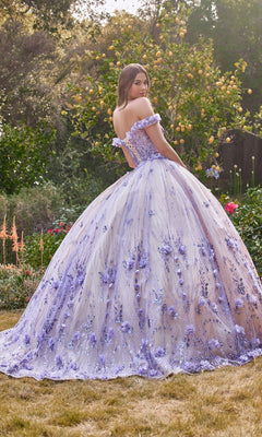 A young woman stands outdoors in the Off-the-Shoulder Quince Ball Gown: Ladivine 15704, featuring a lavender ball gown silhouette with floral embroidery, surrounded by trees and garden flowers.