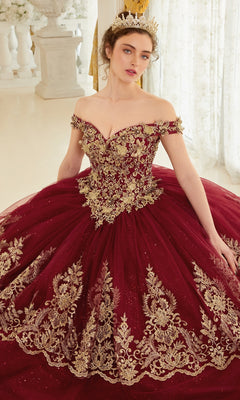 A woman wearing the Ladivine 15705 Quince Dress with gold embroidery and a gold tiara stands indoors against a light background.