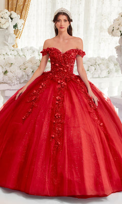 A woman stands in front of a white floral background wearing the Off-Shoulder Purple Quinceanera Dress: Ladivine 15717, featuring glitter, floral appliqués, and a full tulle skirt.