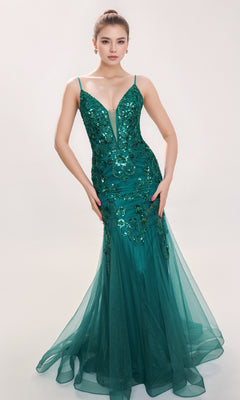 Woman wearing the Nina Canacci 1576, a fitted floor-length green formal dress with sequin embellishments, thin straps, and a mermaid silhouette, standing against a plain light background.