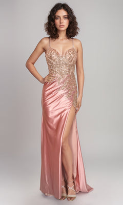 A woman models the Nina Canacci 1585 long formal dress—pink satin with an embellished bodice, spaghetti straps, and a thigh-high slit—paired with strappy heels against a plain light background.