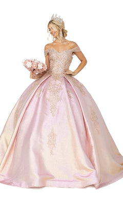 A woman wears the Quinceanera Dress 1585 by Dancing Queen, a ball gown with a sweetheart neckline and gold embellishments, paired with a tiara, chandelier earrings, and holding a bouquet of pink roses.