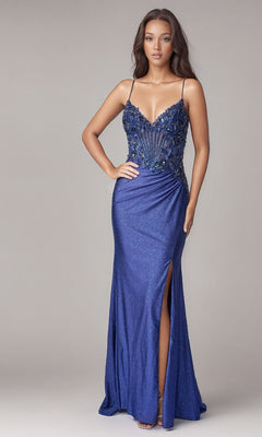 Woman wearing the Long Formal Dress: Nina Canacci 1607 in navy, featuring a fitted embellished-bodice design with thin straps and a high slit—perfect for special occasions—stands against a neutral background.
