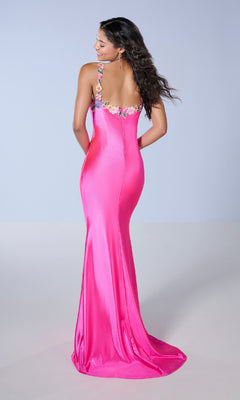 A woman is seen from behind wearing the Tiffany 16145 long prom dress in bright pink, featuring a slim fit and floral embroidery on the straps.
