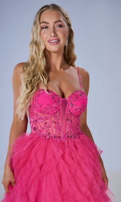 A woman with long wavy blonde hair models the Tiffany 16149 Long Prom Dress—bright pink, beaded, with lace embroidery and a layered tulle skirt—against a plain light background.