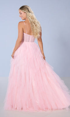 A woman with long blonde hair faces away from the camera wearing the Tiffany 16161 long prom dress, which features a light pink tulle ball gown skirt and delicate spaghetti straps, set against a plain light blue background.