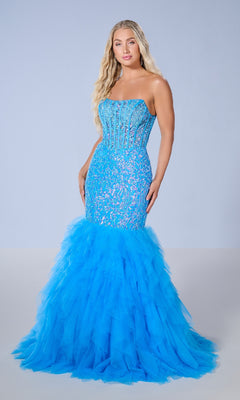 A woman wears the Tiffany 16165 long prom dress, featuring a strapless mermaid silhouette with a lace bodice and voluminous ruffle tulle skirt, standing against a plain light background.
