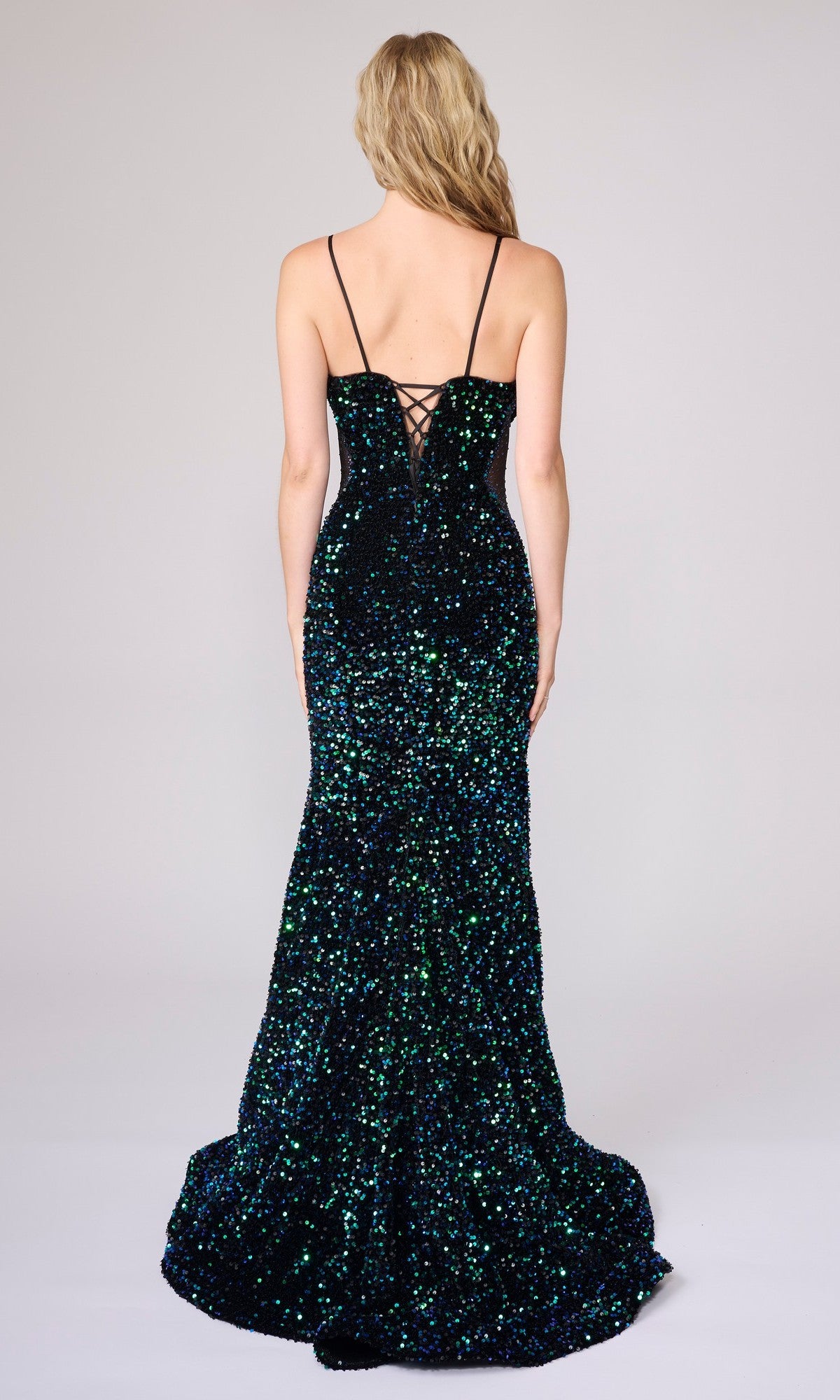 A woman with long blonde hair models the Nina Canacci 1616 Long Formal Dress, a sleeveless sequin evening gown with a floor-length silhouette and adjustable lace-up back, standing against a plain background.