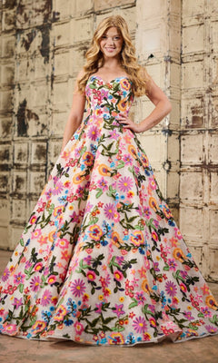 A woman poses by a textured wall, elegantly wearing the Tiffany 16176 Floral Embroidered Prom Ball Gown—a long, sleeveless dress with a fitted bodice and vibrant floral embroidery.