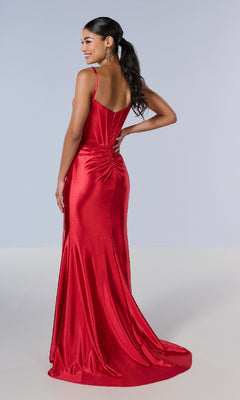 Woman in the Tiffany 16177 long fitted red satin prom dress, featuring a sweetheart neckline and ruched back detail, stands on a plain light background facing away from the camera.