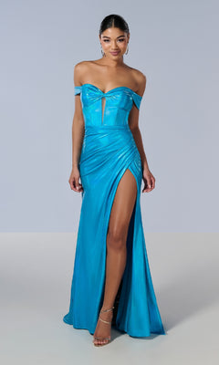 A woman models the Tiffany 16186 long prom dress—an off-the-shoulder, bright blue shimmer jersey gown with a sweetheart neckline, front cutout, ruched waist, and high thigh slit against a plain background.