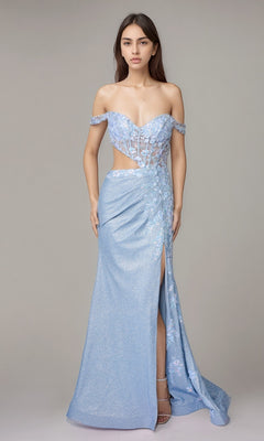 A woman stands against a plain gray background, wearing the Nina Canacci 1618 long formal dress in baby blue, featuring an off-the-shoulder corset bodice, sheer panels, floral details, and a thigh-high slit.