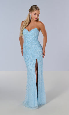 A woman stands against a plain background wearing the Tiffany 16209 long prom dress—light blue, strapless, with a sweetheart neckline, floor-length design, thigh-high slit, and sequin embellishments.