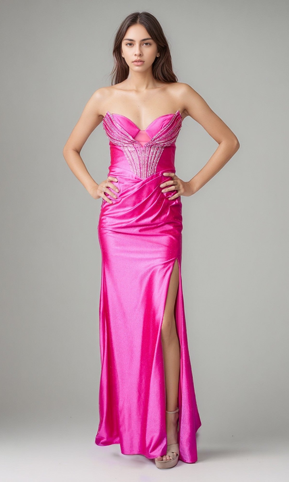 A woman wears the Nina Canacci 1620 long formal dress in fuchsia, featuring a strapless design, beaded bodice, thigh-high slit, and an elegant lace-up back in shimmering satin.
