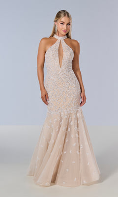 A woman stands against a plain background wearing the Tiffany 16210 long prom dress—a sleeveless, light mermaid gown with sequin embellishments, a front keyhole cutout, and an open back.