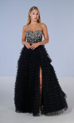 Woman models the Tiffany 16220 long prom dress, showcasing its beaded sweetheart bodice and tiered ruffle skirt, against a plain light background.