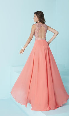 A woman models the Backless Long A-Line Formal Gown in coral pink, featuring an embellished bodice and open back, set against a light blue background.