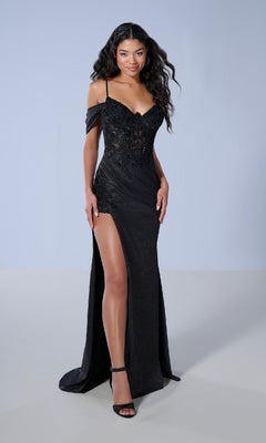 A woman wears the Tiffany 16250 long prom dress—a black, floor-length gown with a side slit, off-the-shoulder straps, and subtle lace embroidery—paired with black heels against a plain light background.