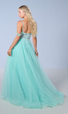 A woman with long, wavy blonde hair wears the Tiffany 16251 Long Prom Dress—a light blue, floor-length A-line gown with a glitter tulle skirt and off-the-shoulder design—facing away from the camera against a plain background.