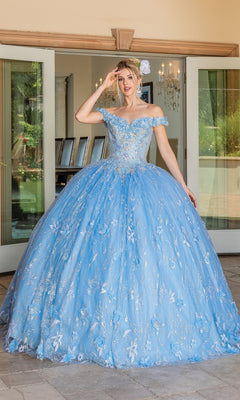 A woman stands outside in front of glass doors, wearing the Quinceanera Dress 1694 By Dancing Queen—an elegant off-the-shoulder ball gown with floral embroidery and a light blue full A-line skirt.