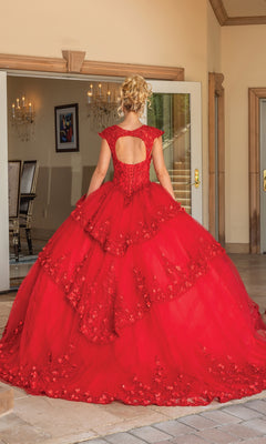 A woman stands indoors, facing away in the Quinceanera Dress 1735 By Dancing Queen—a voluminous red A-line ball gown with lace details and a keyhole back.