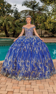A woman in the Quinceanera Dress 1742 by Dancing Queen, featuring lace embroidery and off-the-shoulder straps, stands by a pool outdoors with greenery, wearing a matching tiara.