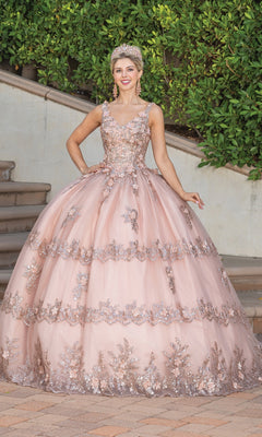 A young woman poses outdoors in front of steps and greenery wearing the Quinceanera Dress 1763 By Dancing Queen, an a-line ball gown featuring floral lace detailing and delicate applique.