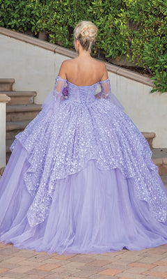 A person with blonde hair in an updo wears the Quinceanera Dress 1773 by Dancing Queen—a lavender, strapless ball gown with floral patterns—while standing outdoors near steps and greenery.