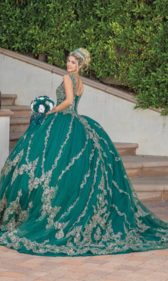 A woman in the Quinceanera Dress 1779 by Dancing Queen, featuring a hunter green ball gown and lace embroidered sweetheart neckline, stands on an outdoor staircase with a matching bouquet and tiara.