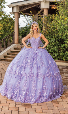 A young woman poses outdoors in front of steps and greenery, wearing the Quinceanera Dress 1808 By Dancing Queen—an a-line ball gown with a sweetheart neckline and delicate lace applique.