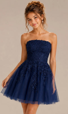 A woman wearing the Jovani 1830 short homecoming dress in navy, a strapless fit-and-flare style with delicate floral lace appliques and layered tulle on the flared skirt, stands against a neutral background.