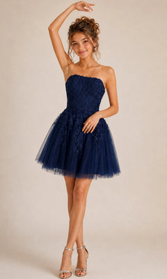 Wearing the Jovani 1830 Short Homecoming Dress in navy blue, adorned with exquisite floral lace appliques over tulle, a woman pairs the strapless fit-and-flare style with silver heels and strikes a pose with one arm raised against a plain background.