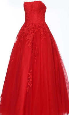 Wearing the Long Formal Dress: Jovani 1831, a strapless red gown with a lace bodice and tulle skirt, adorned with delicate floral appliqués on the upper section.