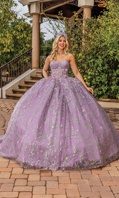A woman poses outdoors in front of stairs and greenery, wearing the Quinceanera Dress 1872 by Dancing Queen—a dusty lilac gown with floral embroidery and a strapless sweetheart neckline.