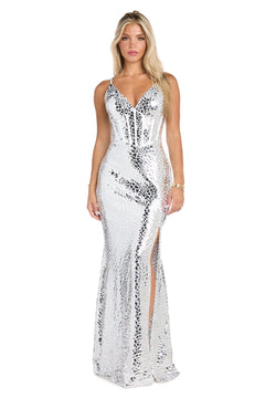 A woman in the White & Silver Reflective Prom Dress: Morgan 19039—a sleeveless, floor-length gown featuring silver sequins, a corset bodice, and front slit—stands against a plain white background.
